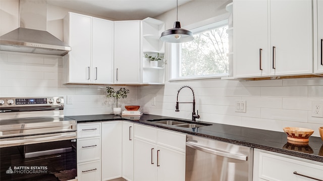 kitchen featuring white cabinetry, sink, stainless steel appliances, and wall chimney range hood