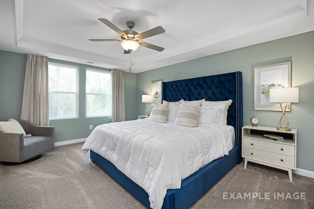 bedroom with carpet floors, a raised ceiling, ceiling fan, and crown molding