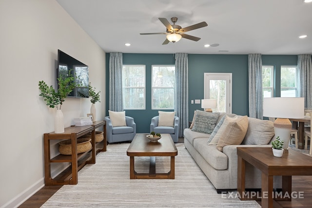 living room featuring hardwood / wood-style floors, ceiling fan, and a healthy amount of sunlight