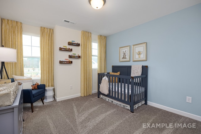 bedroom with carpet flooring and a crib