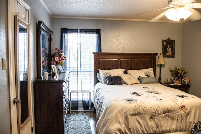 bedroom with ceiling fan, dark hardwood / wood-style flooring, a textured ceiling, and ornamental molding