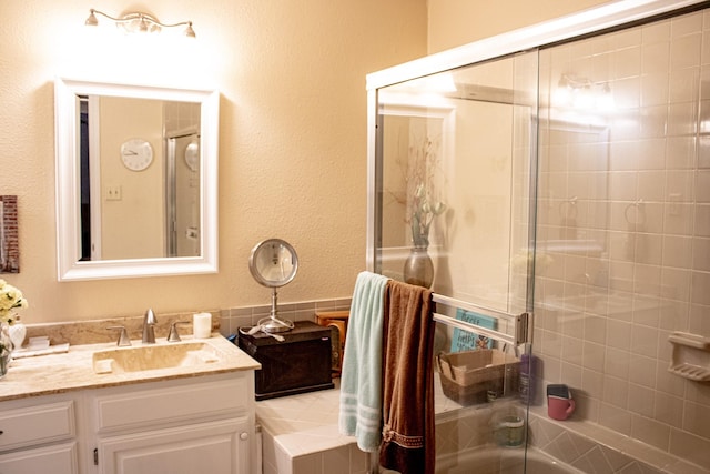 2010 Cloisters Dr Unit 2321, Arlington, TX 76011 - bathroom featuring vanity, enclosed tub / shower combo, and a textured wall