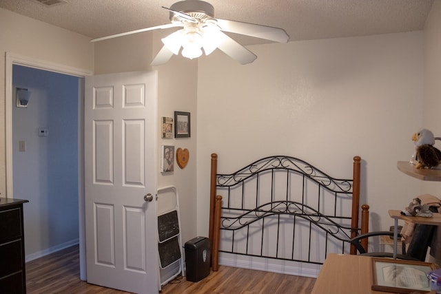 2010 Cloisters Dr Unit 2321, Arlington, TX 76011 - bedroom with baseboards, a textured ceiling, ceiling fan, and wood finished floors