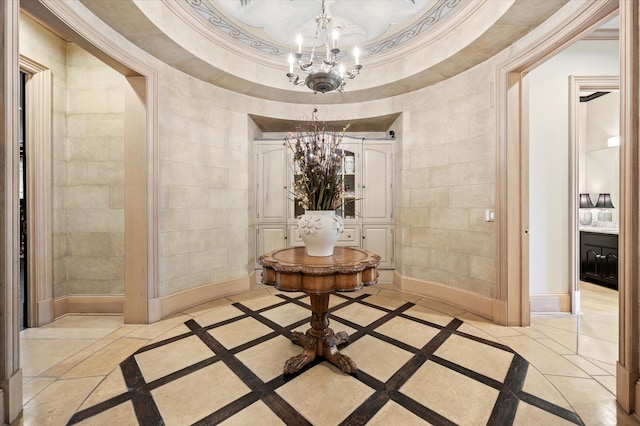 hallway featuring crown molding, a notable chandelier, and a tray ceiling