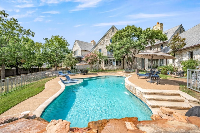 view of pool with pool water feature and a patio area