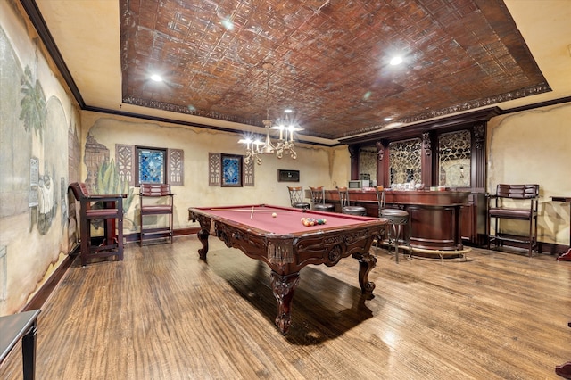 playroom with crown molding, a raised ceiling, and hardwood / wood-style floors