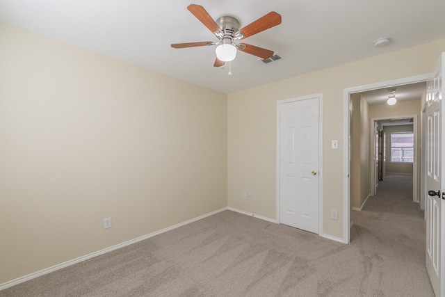 unfurnished bedroom with light carpet and ceiling fan