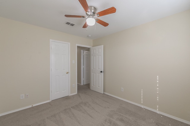 unfurnished bedroom with light carpet and ceiling fan