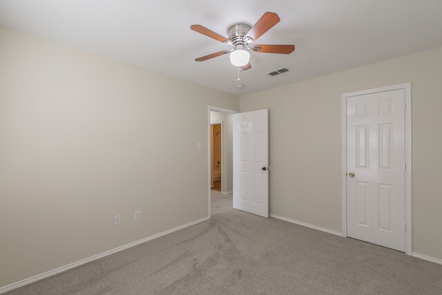 carpeted empty room with ceiling fan