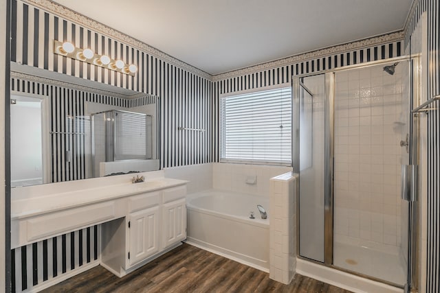 bathroom with vanity, independent shower and bath, and hardwood / wood-style floors