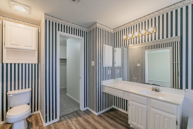 bathroom featuring hardwood / wood-style flooring, vanity, and toilet