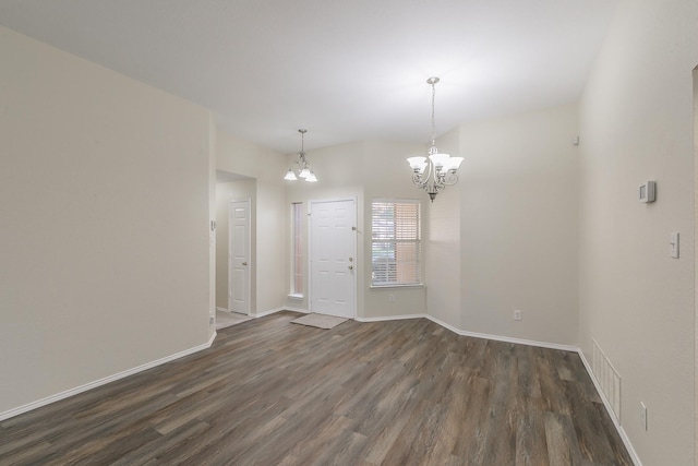 interior space featuring an inviting chandelier and dark wood-type flooring