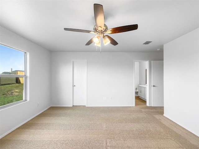 unfurnished room featuring ceiling fan and light carpet