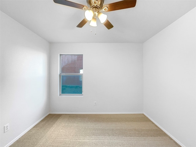 spare room featuring carpet and ceiling fan