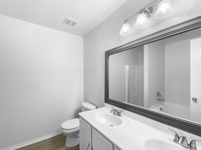 full bathroom with wood-type flooring, vanity, toilet, and shower / tub combination