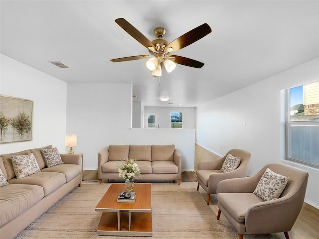 living room featuring ceiling fan and light hardwood / wood-style floors