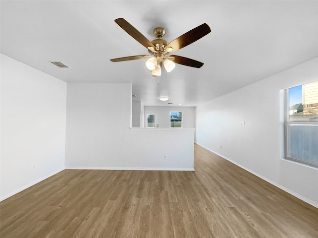 unfurnished living room featuring hardwood / wood-style flooring and ceiling fan