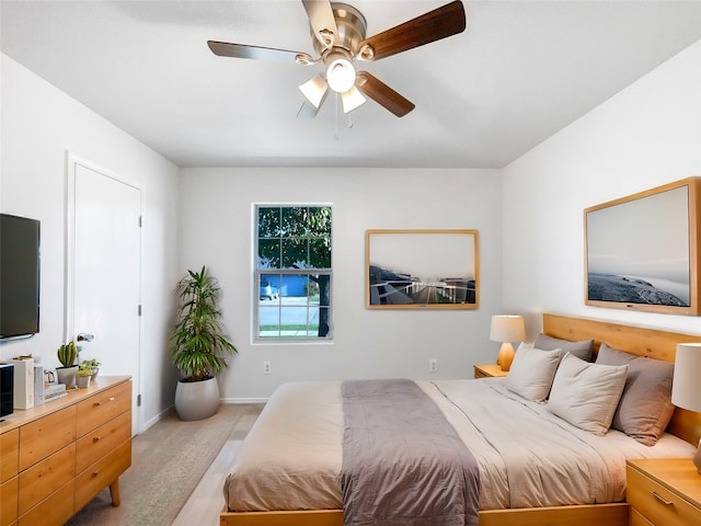 bedroom featuring ceiling fan and light colored carpet