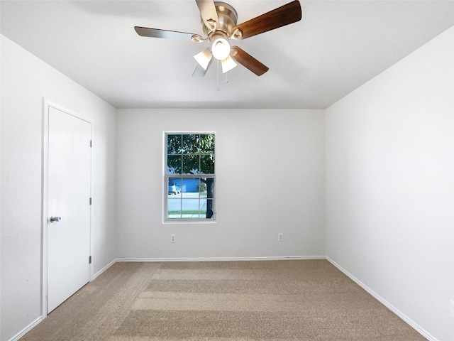 spare room featuring ceiling fan and light colored carpet