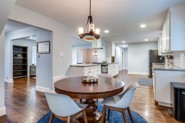 dining area featuring dark hardwood / wood-style floors