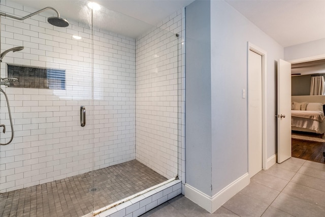 bathroom with walk in shower and tile patterned flooring