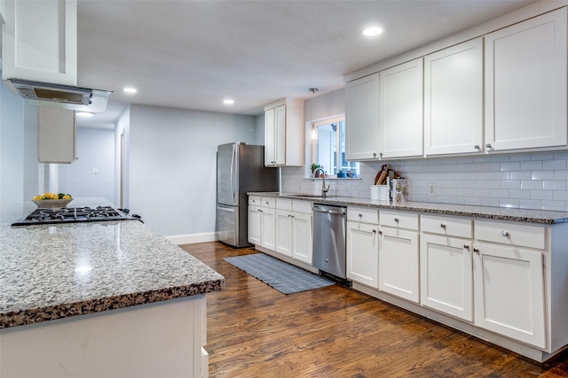 kitchen with stone counters, appliances with stainless steel finishes, and white cabinets