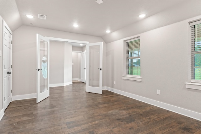 unfurnished bedroom with multiple windows, french doors, dark hardwood / wood-style floors, and lofted ceiling