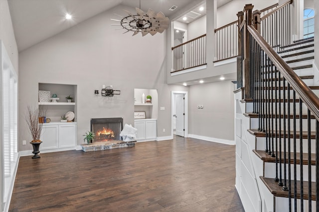 living room featuring built in features, high vaulted ceiling, and dark wood-type flooring