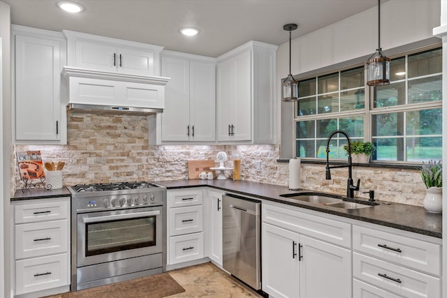 kitchen featuring white cabinetry, sink, stainless steel appliances, backsplash, and decorative light fixtures