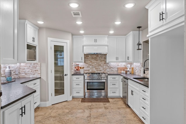 kitchen with custom range hood, stainless steel appliances, sink, decorative light fixtures, and white cabinetry