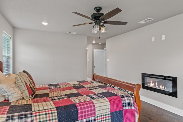 bedroom with ceiling fan and dark hardwood / wood-style floors