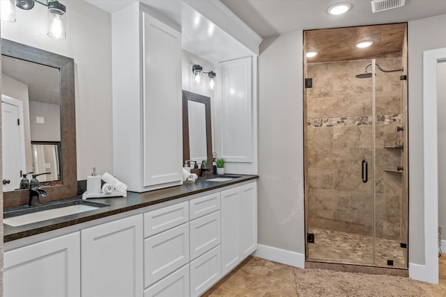 bathroom with tile patterned flooring, vanity, and an enclosed shower