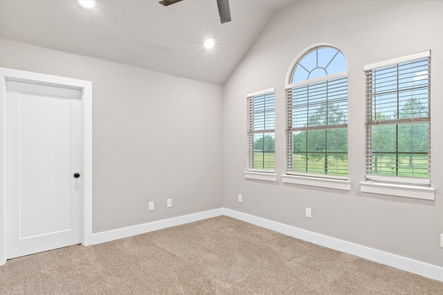 carpeted empty room featuring ceiling fan and vaulted ceiling