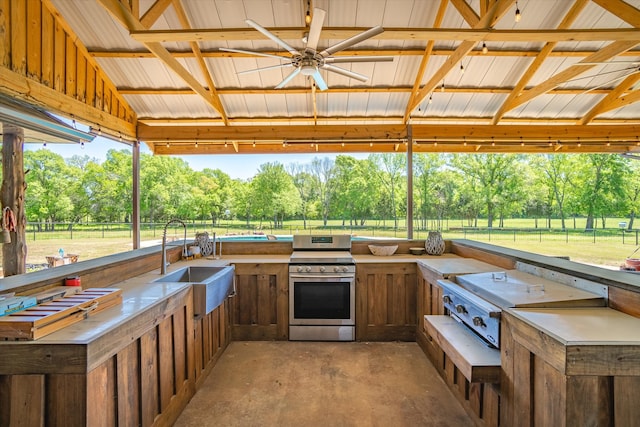 view of patio / terrace with a gazebo, an outdoor kitchen, ceiling fan, and sink