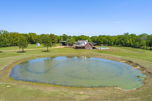 view of home's community with a yard and a water view