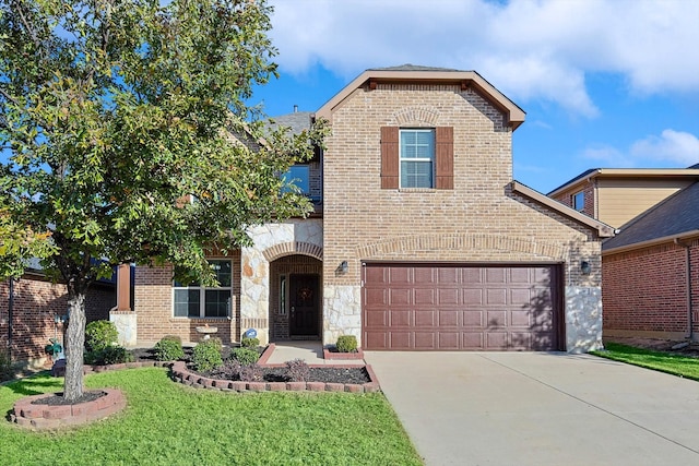 view of property featuring a front lawn and a garage