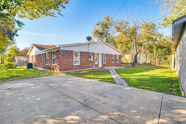 exterior space with a lawn and central AC