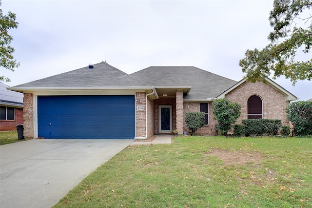 single story home featuring a front yard and a garage