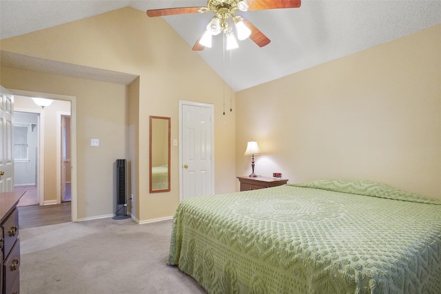 carpeted bedroom with ceiling fan and high vaulted ceiling