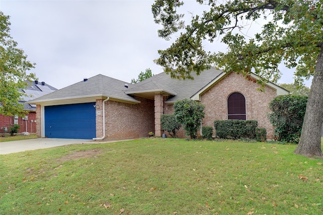 ranch-style home with a front yard and a garage