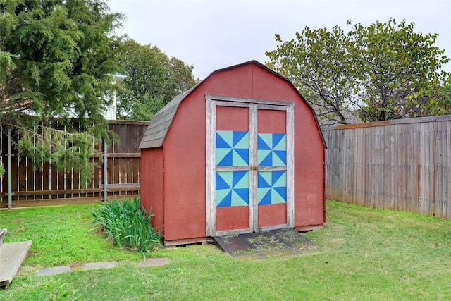 view of outbuilding with a yard