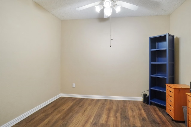 empty room featuring a textured ceiling, dark hardwood / wood-style flooring, and ceiling fan