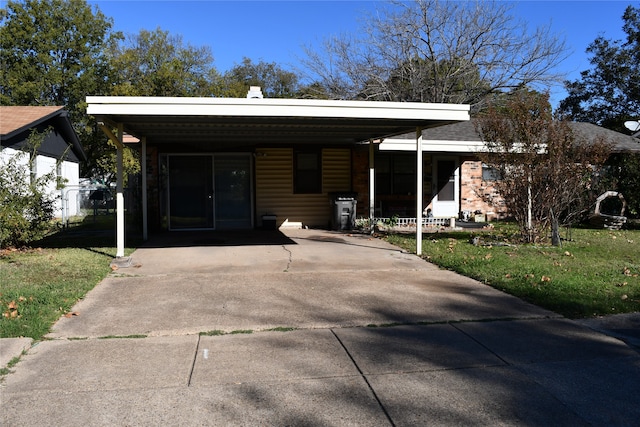 view of front of house with a front lawn and a carport