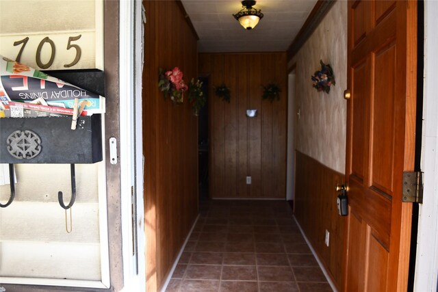 hallway featuring wood walls