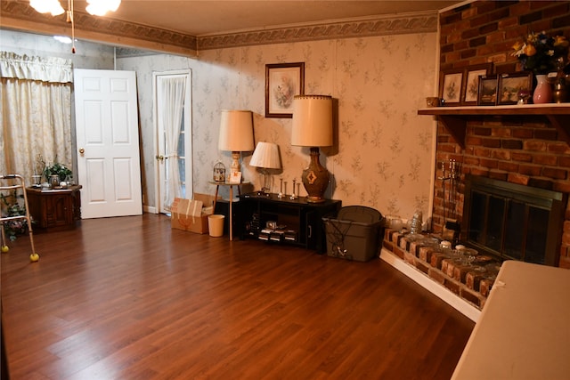 living room with a fireplace and dark wood-type flooring