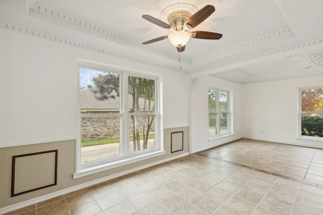 unfurnished room with a tray ceiling, ceiling fan, light tile patterned floors, and a textured ceiling