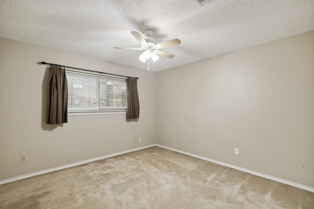 carpeted spare room with ceiling fan and a textured ceiling