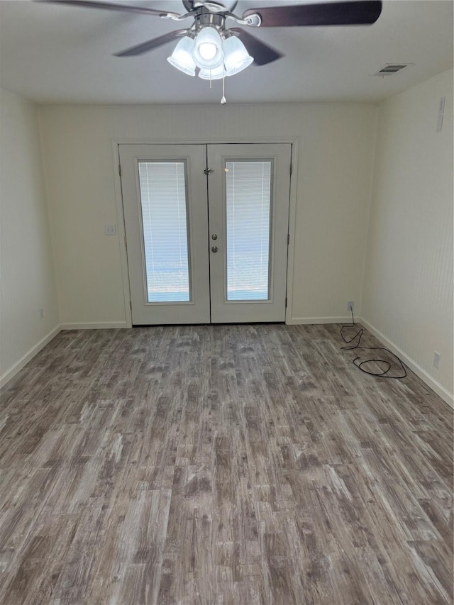 spare room with ceiling fan, french doors, and light hardwood / wood-style floors