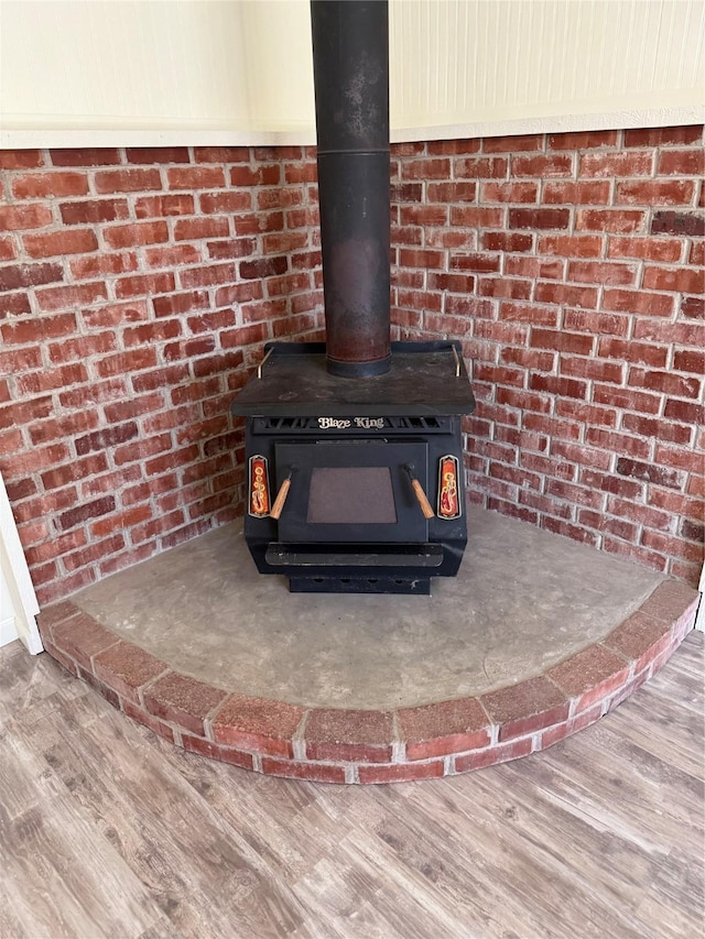 details featuring wood-type flooring and a wood stove