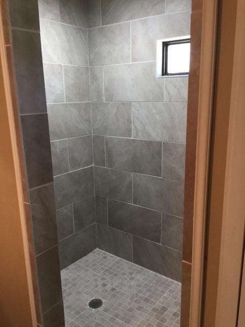 bathroom with tiled shower